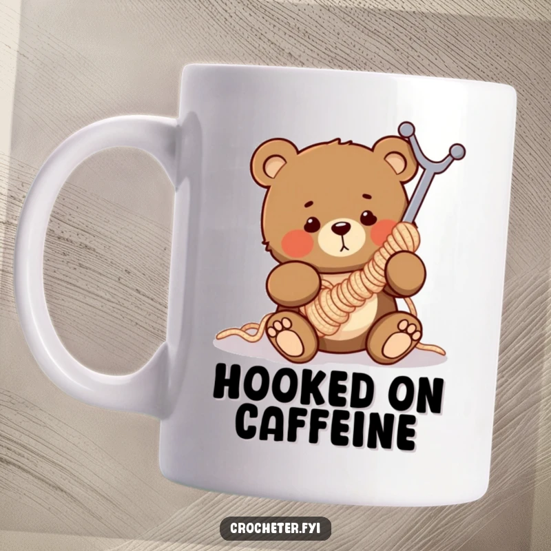 Funny mug showing a clumsy bear comically tangled in a giant crochet hook, perfect for knitting and crochet lovers.