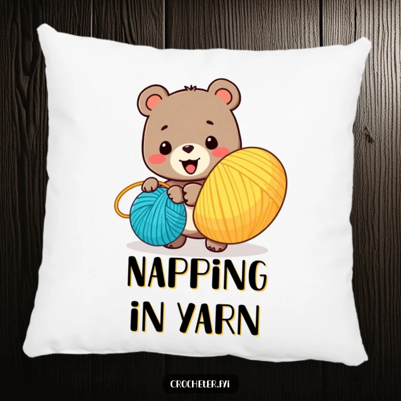 Funny pillow with a smiling bear character winding a large ball of colorful yarn, offering cozy and charming decor.
