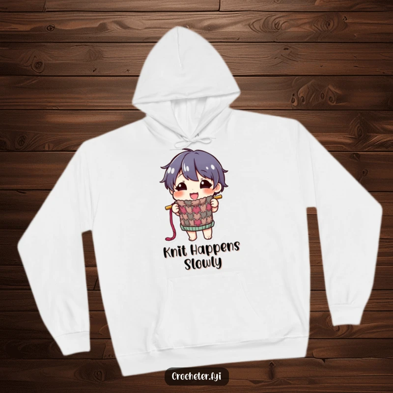 Funny hoodie with a happy character proudly displaying a colorful, half-finished knitted item, ideal for cozy crafting pride.