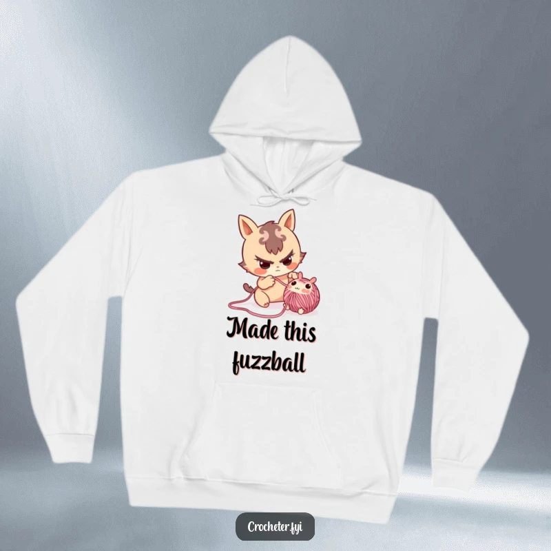 Funny hoodie showing a mischievous character playfully pulling a small yarn critter from a crafting project.