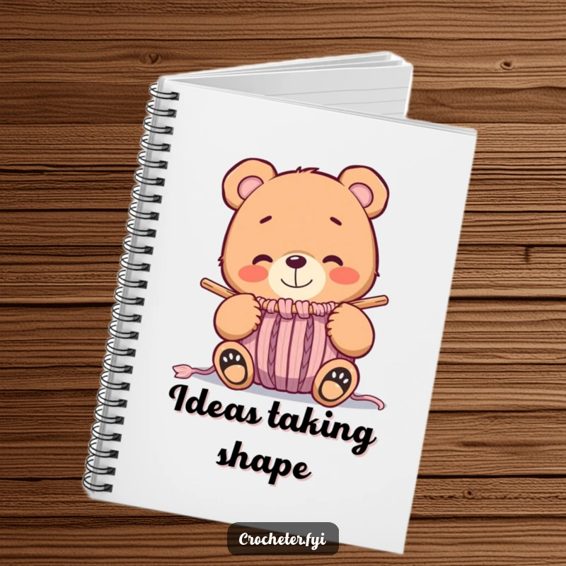 Funny whimsical bear smiling at a nearly finished knitted item, a humorous notebook cover for creative planning.