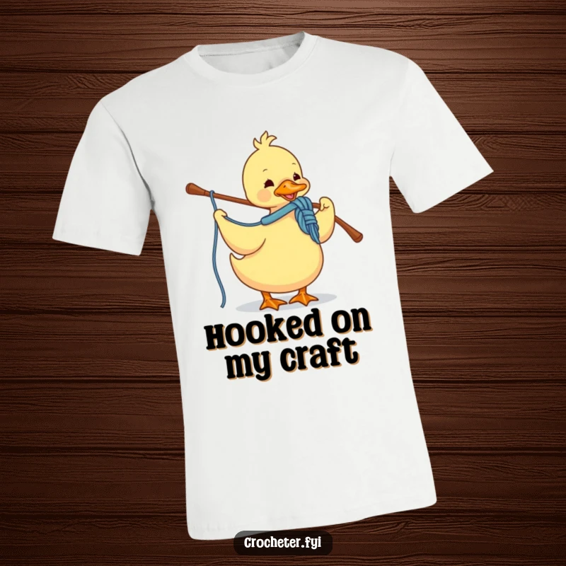 Funny T-shirt showing a diligent duck engrossed in crocheting with colorful yarn and a hook, celebrating the craft.