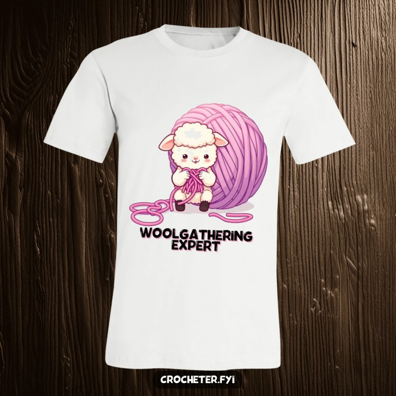 Funny Sheep T-Shirt depicting a small, fluffy sheep battling a massive, tangled ball of yarn while attempting to knit, a humorous crafting scene.
