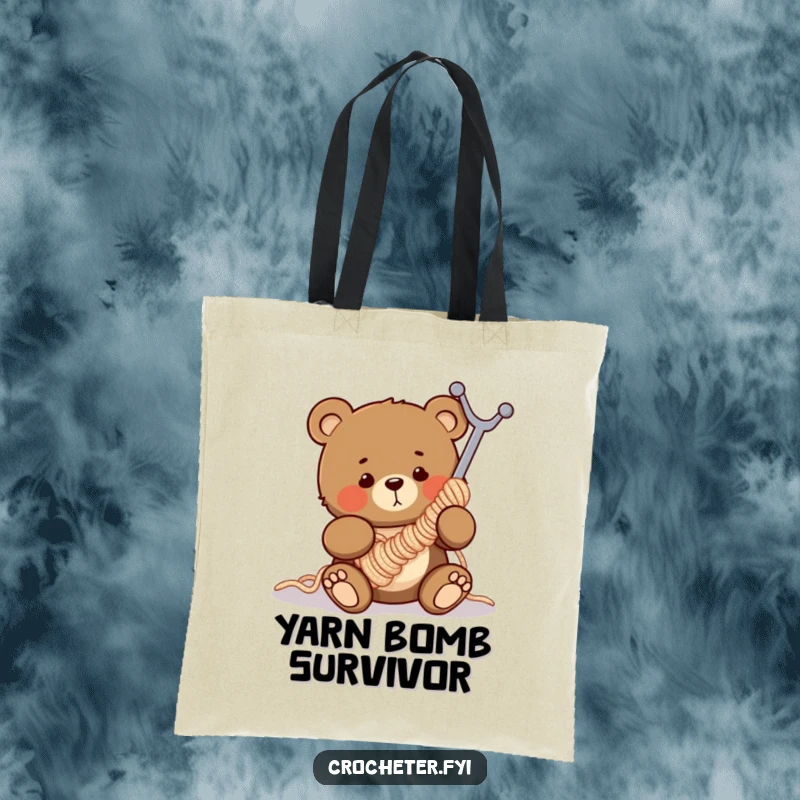 Funny tote bag with a clumsy bear comically entangled in a large crochet hook, ideal for yarn and craft supplies.